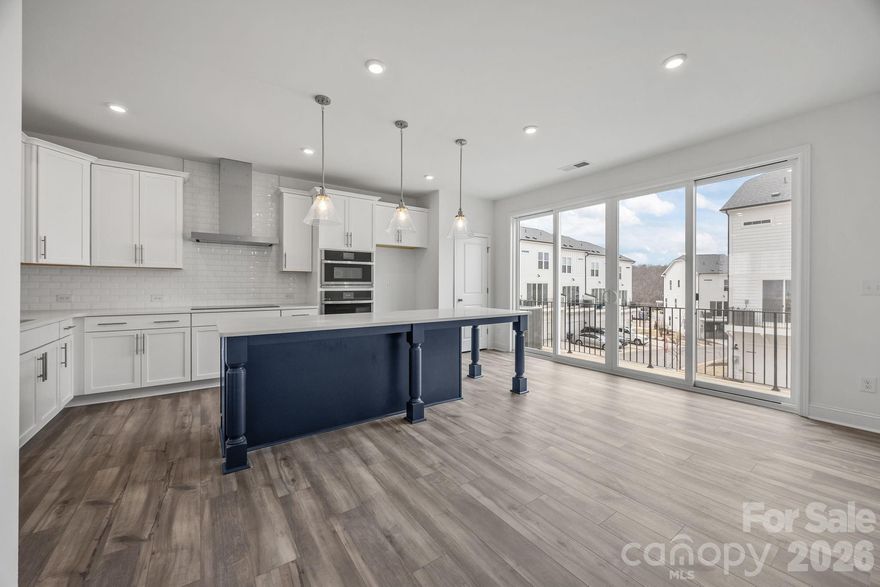 Welcome to The River District—a true master-planned community where lifestyle and location come together beautifully.

This beautifully appointed Landon three-story townhome offers a thoughtfully designed layout with a first-floor guest bedroom and full bath—perfect for visitors, multigenerational living, or a private home office.

The second level showcases a gourmet kitchen featuring quartz countertops, a built-in oven and microwave, electric cooktop, and soft-close cabinetry. The open-concept dining and living areas create an inviting space ideal for entertaining, while sliding glass doors lead to your private balcony—perfect for relaxing or enjoying your morning coffee.

Upstairs, you’ll find two beautiful owner’s retreats, each offering a bright, airy bedroom and a spa-inspired bath for ultimate comfort and privacy. A conveniently located laundry area completes the upper level.

This home is filled with beautifully curated interior finishes, individually hand-selected by our professional design team, creating a cohesive and elevated aesthetic throughout.

Location is everything—and at The River District, you’re truly minutes from it all. Planned community amenities include a resort-style pool, clubhouse with fitness center, tennis and pickleball courts, parks, scenic trails, a working two-acre farm with an on-site farmer, and a riverfront amphitheater.

Experience vibrant, connected living in one of the area’s most exciting communities.