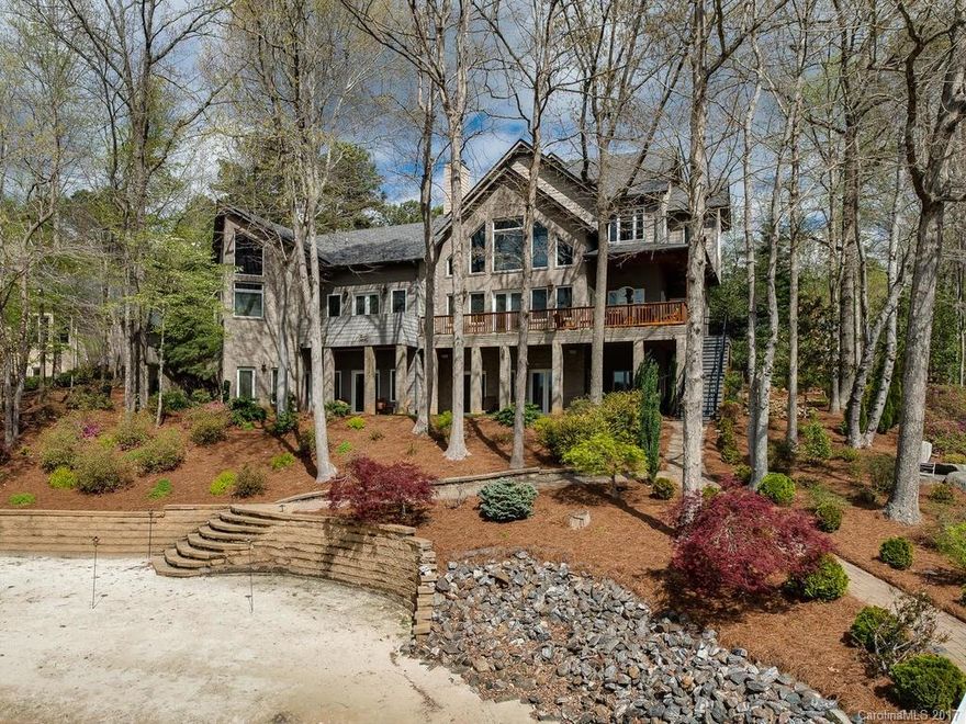 Casual Elegance Defined! Exquisite waterfront estate w/gorgeous views overlooking LKN park. Beautiful sandy beach & lush landscaping. Trex pier w/2 boat slips/lifts & 2 jet-ski ports. Lakeside master retreat w/fireplace, private office & laundry; magnificent bath w/whirlpool tub & double shower. Gourmet kit. w/Viking/Sub-Zero appliances. Great room w/soaring ceilings & massive stone fireplace. Second living quarters in lower level w/custom wine cellar. Detail abounds in this "lodge-like" beauty!