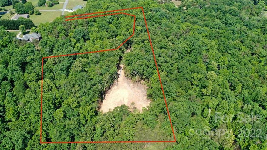 CALL FOR BEST AND HIGHEST by Sat (6/18) at 8pm.   RARE FIND: The privacy of tranquil woods in coveted Belmont without an HOA!  This beautiful, private lot boasts a total of just over four and a half acres, mature Cypress, Oak and Poplar trees, toward the end of Minnie Queen Lane.  The lot slopes down at the front of the property, which serves as a natural separation between lots. 
Ready to Build:  The construction driveway has been installed, a great homesite location has been cleared and the well and septic permit has been approved.  The land has perc'ed for 5 bedrooms.  There are no city taxes or HOA fees. This lot is close to the new Morning side marina/restaurant that offers boat slips and dry boat storage options and the Daniel Stowe botanical gardens.  It is also 10 min from downtown Belmont and less than 30min from the airport.  Belmont schools. Address has not yet been assigned.