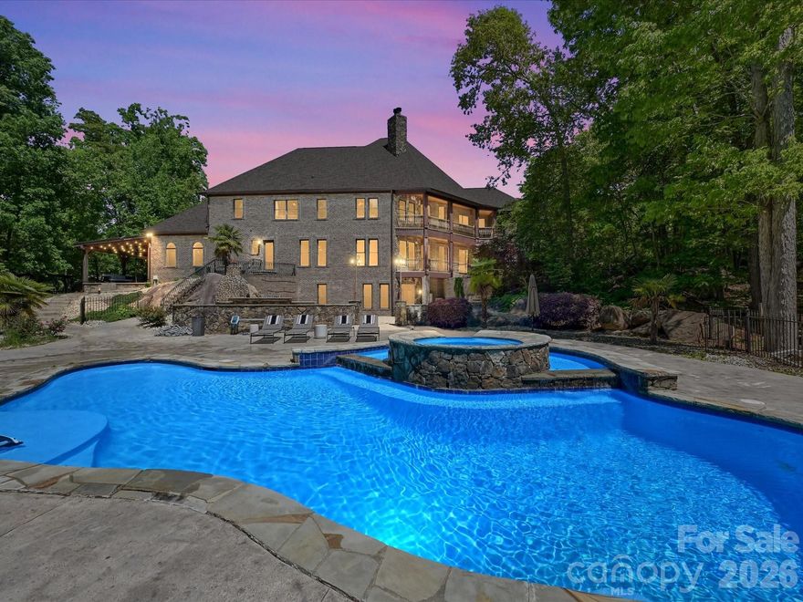 Tucked away on 10.31 private, wooded acres just minutes from the heart of Waxhaw, this stunning estate offers a rare blend of luxury, privacy, and natural beauty. A gated entrance and winding quarter-mile driveway create a true sense of arrival, leading to an impressive 8,276 square foot home thoughtfully positioned within a serene, nature-filled setting.
Built in 2007 and beautifully maintained, the home features 4 bedrooms per septic permit (with 5 total bedrooms), each with its own full bath, offering flexibility for guests, multi-generational living, or private office space. The main-level primary suite is a true retreat, complete with a spacious en-suite bath, dual vanities, and peaceful views of the surrounding landscape.
The main level is designed for both everyday living and entertaining, featuring a granite kitchen that opens seamlessly to the expansive great room, along with formal living and dining spaces. Architectural details and custom ornamentation throughout the home add a refined, upscale feel while maintaining warmth and livability.
Upstairs, generously sized secondary bedrooms, a large loft, and an oversized bonus room provide flexible space for work, play, or relaxation. The fully finished walkout basement is built for entertaining, featuring a media room, bar area, game room, recreation space, and full bath—flowing effortlessly to the outdoor living areas.
Outdoor living is exceptional and truly sets this property apart. A multi-level deck overlooks the natural landscape, while the expansive patio—crafted from massive, natural stone—creates a one-of-a-kind outdoor gathering space. The gunite inground pool has been recently enhanced with new variable frequency drive (VFD) systems for improved efficiency and long-term cost savings. A tranquil seasonal creek runs through the backyard, further enhancing the peaceful, private setting.
The property is well-equipped for both lifestyle and functionality, featuring multiple outbuildings ideal for ATVs, tractors, and equipment, along with a 3-car garage and additional covered parking for two more vehicles.
Additional highlights include two fireplaces, whole-house water filtration system, new roof (2025), HVAC system (2025), new gutters, and extensive interior and exterior repainting. Spectrum fiber internet availability makes working from home seamless, even in this private, tucked-away location.
Zoned for Waxhaw Elementary, Parkwood Middle, and Parkwood High School, with many area families also choosing nearby Union Academy charter school.
This is a rare opportunity to own a private estate offering acreage, luxury, and convenience—just minutes from Waxhaw, while still within easy reach of Ballantyne, South Charlotte, and everything the region has to offer.