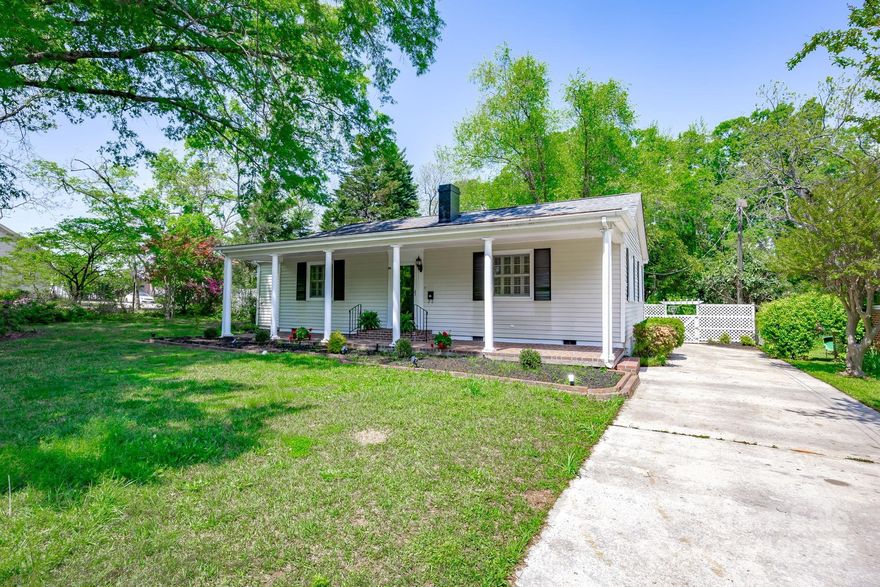 This updated 3/2, 1948 classic in historic Winnsboro on over 1/2 acre with mature landscaping, charm, space, and flexibility, all with no HOA. Spacious layout with a large, refreshed dine-in kitchen with granite countertops, breakfast Bar, updated appliances and a cozy keeping room area perfect for casual hangouts. A formal dining room and inviting living room are ideal for entertaining. The primary bedroom offers something special with a private sitting area plus a sunken room with built-in cabinetry. Once an artist's studio, it can be a home office, yoga room, creative space—you name it. The primary bedroom with en suite includes two separate closets. Original hardwoods run through most of the home, now protected by new laminate flooring for easy maintenance. Moldings throughout add the right touch of character. Spend mornings on the front porch and evenings on the back deck overlooking the spacious fenced backyard. Fresh paint and thoughtful updates make this home move-in ready.