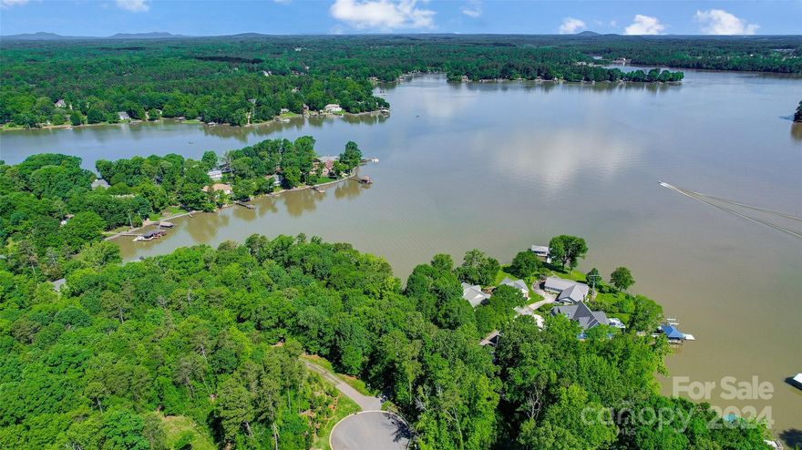 Gorgeous waterfront lot offering long-range panoramic views of Lake Wylie. This 2.25-acre property is the perfect canvas for building your dream home and enjoying the ultimate in lakeside living. Nestled among mature trees for privacy and shade, the property boasts a charming lake cabin that can be enjoyed “as is” for weekend retreat or build/update when ready, a natural shoreline, and gently sloping yard that provides easy access to the water. The expansive covered dock with lift and beach allows you to fully embrace the lakefront lifestyle. Imagine waking up to picturesque lake views every day. This exceptional property is the perfect blend of tranquility and convenience, with easy access to the Buster Boyd Bridge, restaurants, and shopping. Benefit from award-winning Clover schools and the advantages of South Carolina taxes.