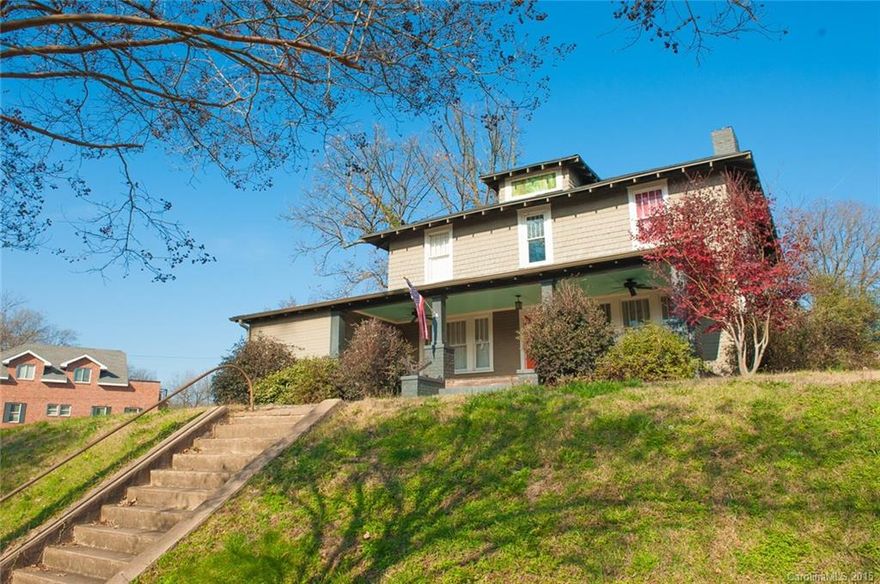 Crown jewel of the neighborhood waiting for your polish and shine! This original four-square craftsman home is unusual in Wilmore - far larger than most, 2 story and sits high on the hill at the corner of Park & Mint. Original features throughout including french doors to study, wide upper hallway w wooden newel posts & woodwork. HUGE front porch! Baths have been updated, kitchen / dining have been opened and updated as well. 4 bedrooms and den upstairs. Walk to light rail, uptown, stadium.