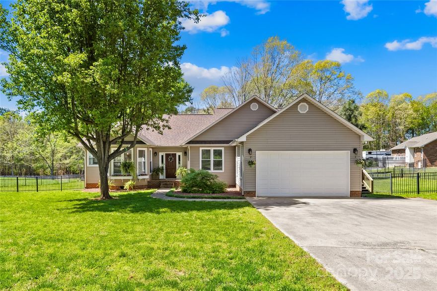 Tucked away in the sought-after Northshore neighborhood of Cherryville, this 3-bedroom, 2-bath home offers comfort, charm, and a fantastic location just a short distance to Moss Lake. Step inside to a light-filled living room with soaring vaulted ceilings, stylish updated lighting, a beautiful chandelier, and built-in cabinets surrounding cozy gas logs. The kitchen is both functional and inviting, featuring a gas range, stainless steel appliances, breakfast area, and a bay window that lets in the morning sun. The formal dining room is currently used as a music room—perfect as-is or ready to fit your needs. The spacious primary suite is a true retreat, boasting vaulted ceilings, a separate sitting area, and a luxurious en-suite with double vanities, a garden tub, a separate shower, and a walk-in closet. Enjoy outdoor living in the large, fully fenced backyard with a wired outbuilding—ideal for a workshop or extra storage. This one checks all the boxes—style, space, and location.