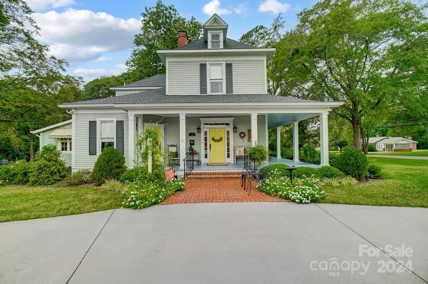 Picturesque Victorian home with a sweeping wraparound porch. A meticulous renovation in 2017 has preserved the original charm while offering modern updates, including wood floors, 10 ft ceilings, crown molding, 8-inch baseboards, four fireplaces, beadboard ceilings, and chandeliers. The first floor offers a formal living and dining room, a Guest Bedroom/office with access to the porch, a Den, a laundry room, and a full bath—a chef's kitchen with an island, granite, SS appliances, a gas range, wall oven, a breakfast area, and a pantry. The second floor offers a primary bedroom with a private bath, a double tile walk-in shower, and a walk-in closet. 2 large additional bedrooms share a full bath. The enchanting yard features a circular driveway and patio leading to the detached two-car and two-story wired garage, within walking distance to downtown Dallas with shops and restaurants—Aquatic Center to come to the town of Dallas. Offering 1 Year Home Warranty.