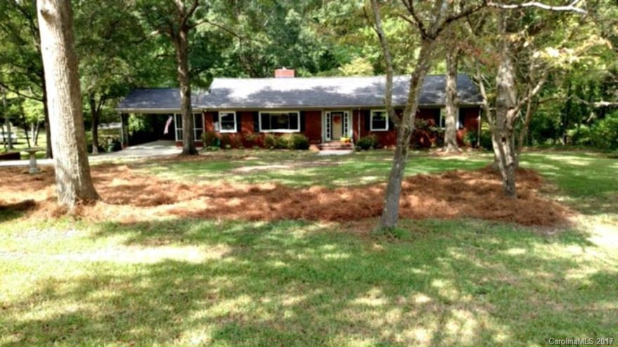 Beautiful brick home in Forest Hills!  Updated kitchen with granite counters and white cabinets.  Two wood burning fireplaces - one on main and one in basement.  Walkout basement has bedroom, family room, and utility.  Large level, wooded lot with separate outbuilding.  Relax on the screened porch, side porch, or back patio -- all perfect for personal enjoyment or entertaining.  Come see this beautiful home now before its gone!