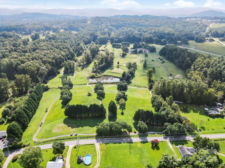Once in a lifetime opportunity. This amazing property is centrally located and convenient to most everything in Hendersonville. It consists of 32.85 lovely acres, and has never been on the market. Currently operating as an 18 hole executive golf course, but located in the Henderson County LC zoning district, so a plethora of uses are possible. The land is level to gently rolling, with a stream and pond to add to the absolute beauty of the property. Improvements include a clubhouse w/refreshments serving room and bar, 2 ample offices, indoor lounge area and open air seating on outdoor deck area. Also includes 5000 sq' metal golf cart barn and paved parking lot with approx. 65 spaces. Please Note: Golf Course is currently operating as a business, as such, we ask to contact listing broker if you have questions. Sellers have requested no showings without making appt with listing broker. Please see LC Zoning Details in listing attachments for wide range of permitted uses.