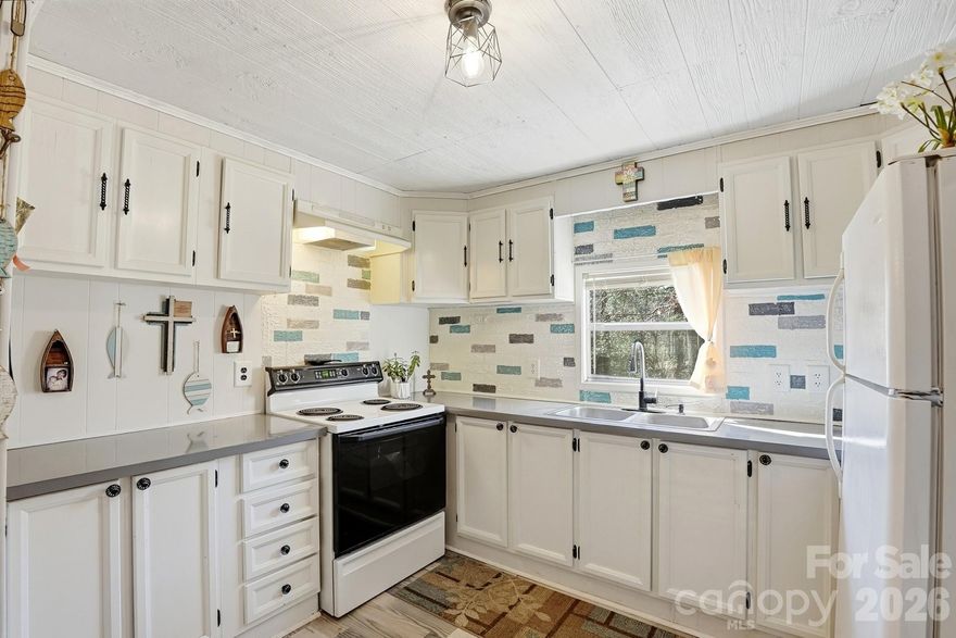 Don't miss this 3BR/2BA home on .74 acre in Dallas! This 1440 sq ft manufactured home includes a bright, updated kitchen, newer laminate flooring and a separate dining room. Besides the living room, there is also a large family room with sliding doors accessing the porch and back yard. The home includes three large bedrooms. Per seller, the roof was cool sealed in 2022, and the septic system was last pumped in 2023. 2010 HVAC. Let's talk about the DETACHED GARAGE! This 30x50 building can house multiple vehicles, store just about anything you can think of, or become a functional workshop. Fireplace has not been used in years, per seller. Home and buildings sold as-is. Peaceful, private corner lot with easy access to Gastonia.