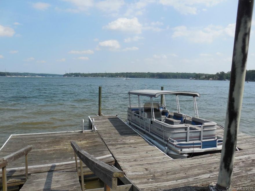 BIG WATER WITH OPEN 2 MILE VISTA IN PRIVATE, PREMIER ISLAND NEIGHBORHOOD- NO HOA! Waterfront paradise over 150 ft sandy beach shoreline. Amazing sunrise view on this main channel gently sloped lot. Home has some updates & additions in 1994. Open floor plan features 3 bedrooms, 3 full baths plus 1/2 bth.  Bonus room shaped into Bunkroom for kids. Perfectly located to shopping & quick commute to Clt. Excellent Clover Schools & LOW taxes. RARE opportunity to buy in this serene island paradise.