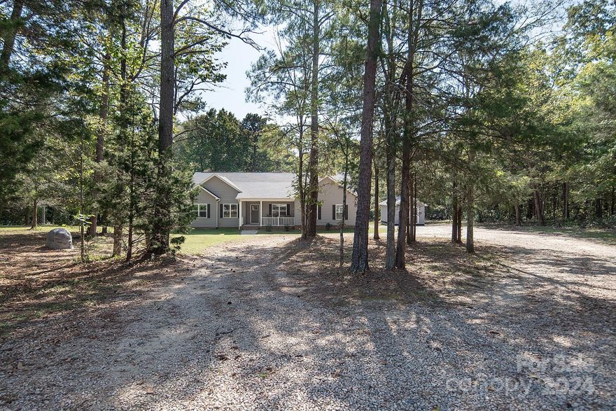 Discover your dream home on 3.13 wooded acres in this charming neighborhood of Concord! This beautifully maintained property features 3 bedrooms and 2.5 baths.  Open concept seamlessly connects the living, dining, and kitchen areas, making it perfect for entertaining and gatherings.  The kitchen has upgraded stainless steel appliances, granite and backsplash. Enjoy cozy evenings by the wood burning fireplace in the living room.  Or step outside on the new extended deck, surrounded by woods for privacy, ideal for relaxation and outdoor entertaining.  Located mins. from town, Carolina Mall, Atrium Hospital, schools, parks, shopping centers, and I-85, this home combines convenience with tranquility. 
Don’t miss your chance to own this gem in Concord! Schedule a showing today and experience all that 3000 Penninger Rd. has to offer. **Home will convey Refrigerator, Water Softener System, 1 Workshop Shed, 1 Storage Shed, 1 Woodshed, 1 John Deer Tractor at zero value. **Agent is the Owner**