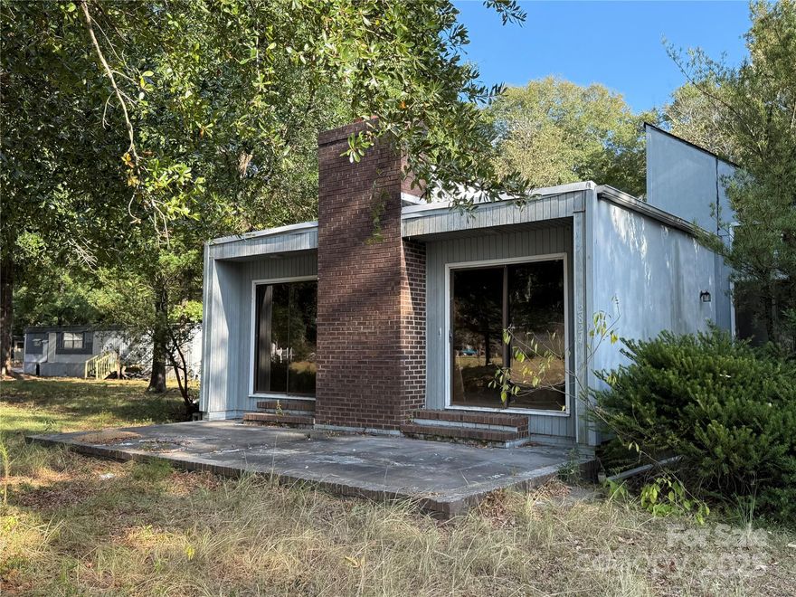 Versatile Investment Opportunity – 2 Bed, 2 Bath Contemporary Property on .76 Acre Lot

Discover this unique 1979 contemporary property offering endless possibilities! Featuring 2 bedrooms, 2 bathrooms, a cozy fireplace insert, and a screened breezeway leading to the garage with attic space, this property is ideal as a home, office, or creative mixed-use space.

Situated on a .76 acre surveyed lot, the property is zoned for both residential and commercial use, giving you flexibility for your vision. Power and water are already on, providing a head start for your plans (note: Darlington County Water & Sewer does not provide disposal system).

This property is part of an investor’s portfolio purchased site unseen and has not been occupied or inspected by the current owner. With its prime location and adaptability, it’s a fantastic opportunity for someone looking to create value—whether you envision a comfortable home, a professional office, or something entirely new.

Don’t miss out—call today to schedule your private showing!
