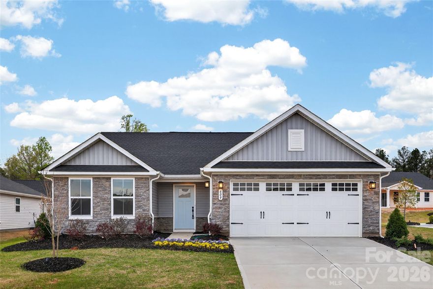 MODEL HOME WITH OVER $25,000 in PREMIUM FEATURES. Inside, enjoy an open-concept layout perfect for entertaining and everyday living. The gourmet kitchen features granite countertops, stainless steel energy-efficient appliances, and a stylish tile backsplash, complemented by luxury vinyl plank flooring throughout the main living areas. Elegant curtains add warmth and privacy, while the polished, move-in-ready feel requires no extra work.

Additional MODEL HOME features include luxury side-entry door, an upgraded garage with designer finishes, and thoughtful upgrades like Downin Duraform Harbor cabinetry, cultured marble bathroom countertops, Golden Cove Cascade carpet with premium padding, hard-surface flooring in the great room, LED lighting, and a chef-inspired kitchen with tile backsplash. The spacious owner’s suite offers a spa-style ceramic surround shower, and the fully painted garage (former builder’s office) provides abundant outlets—ideal for hobbyists or a home gym.

Perfectly located just off Highway 521, you’re minutes from downtown Lancaster, Indian Land, and South Charlotte. Enjoy low-maintenance ranch living with community amenities including a firepit, dog park, walking trails, and pickleball courts. Nearby attractions feature Lancaster Golf Club and the Promenade at Carolina Reserve for shopping and dining.