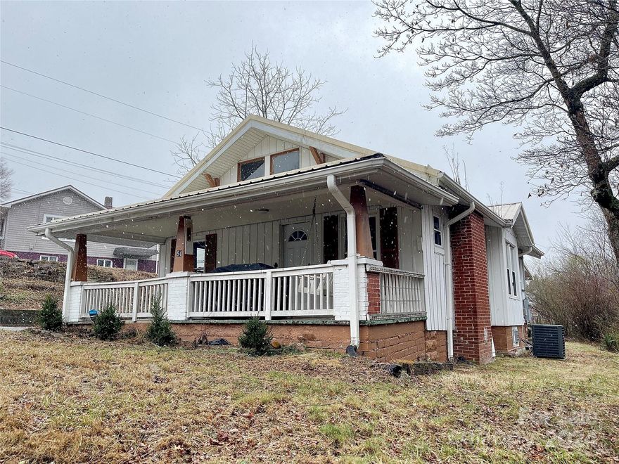 EVERYTHING ON ONE LEVEL!! Arts & Crafts Home that is Move-in Ready, 2 large bedrooms with 1 and 1/2 baths. Spacious Kitchen with small pantry, Dining Room, Large Living Room with brick gas logs fireplace and Laundry all on main level. Floors are vinyl laminate, tile.  Laundry located in full bath with connections for washer and dryer. Heating and air conditioning is supplied by an electric heatpump and there are two propane gas space heaters installed also.  All windows are vinyl clad replacement windows that tilt for cleaning. Large bedroom on back of house has private outside entrance. Large covered front porch with swing to watch pets play in the front yard.  Also a nice backyard too. A Detached workshop with electricity that would be good workshop or craft studio. Very Convenient Location-Walk to Riverside Park, Cross St Complex, Ingles & Downtown. Unfinished basement-great for additional storage; plenty of off-street parking; great rental investment property.