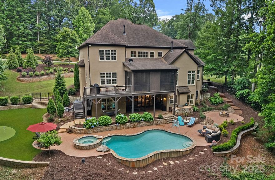 Exquisite custom 2 story home with a walkout basement on 2 private acres in sought after Anniston, designed for luxurious living and unforgettable entertaining! The resort-style backyard features a heated saltwater pool & spa, putting green, fire pit, and lush landscaping. Inside, high-end finishes and detailed millwork enhance this open floor plan, including a grand 2 story great room with stone fireplace, gourmet chef’s kitchen with custom cabinetry, gas cooktop & double oven, as well as the sunny breakfast room. The wine bar and keeping room with cozy gas fireplace offer intimate gathering spaces, while the three-seasons room invites year-round enjoyment. Main-level primary suite with spa inspired bath. Private executive office. Upstairs offers 3 bedrooms, 2 baths, large bonus and versatile media room. The finished daylight basement adds a full living area, kitchenette, gym, workshop, & second primary suite perfect for guests or multi-generational living. This home truly has it all!