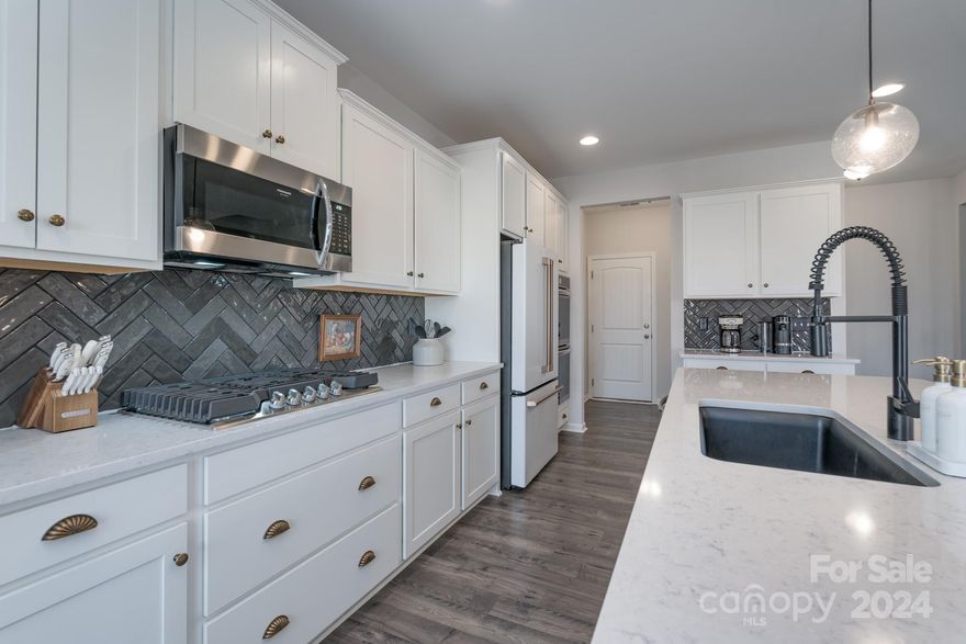 LIKE NEW, bright and sunny. 5BR, 3 Full Bath home. Flex room on main with closet., office or BR.  Gourmet kitchen cabinets with crown molding and expansive quartz counters on Huge Island.  Two pantries/closets in kitchen and are both very large.  Enjoy the conversation room while walking into the home.  Office/flex on main floor. Owners' suite on second floor with tiled walk-in shower, laundry room connects to the Owners Suite, and closet is above the garage and is huge.  This home is move in ready. 

The Best covered patio and woods behind, fenced back yard with a pasture in back to watch the cows graze.  This home is a real gem, everywhere you look, well-appointed upgrades and features.  Enjoy morning sun shining on the pasture from the Owners Suite.  Afternoon sun on front of the house.  Front facing SW.  Both great places to enjoy your coffee or an evening beverage.