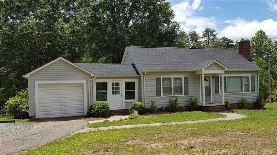 Very well kept older home on 10 acres backs up to North Lincoln high property. Recently refinished hardwoods in bedrooms, LR and hall.  Recently painted. Small creek runs across back of mostly wooded land, cleared in front with the house.  Includes 2 parcels.  Separate storage garage, will also house a small vehicle. 1 year home warranty included.