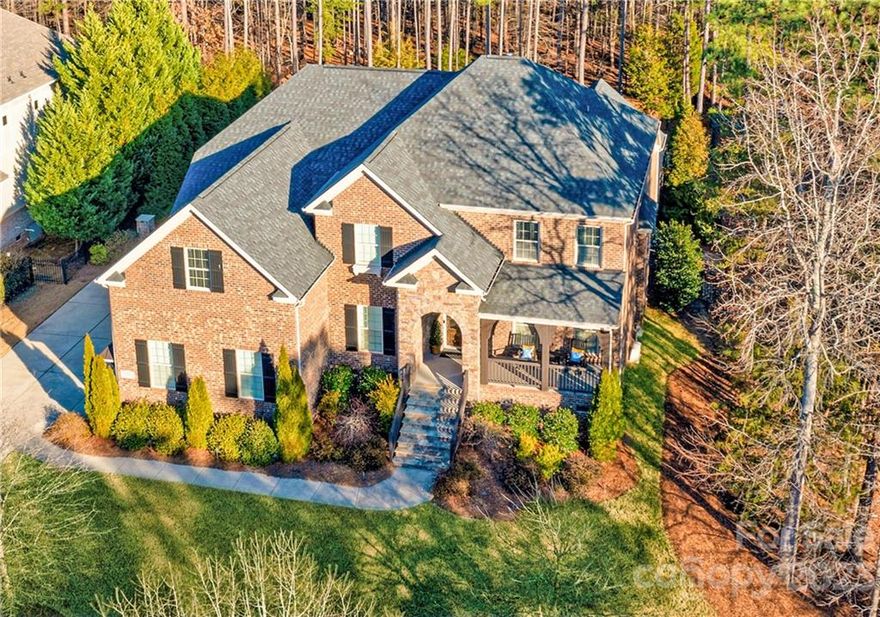 This gorgeous custom home is located in the gated community of Ashton Oaks in the amenity-rich Palisades. The grand two-story foyer leads through an arched entryway to the great room & morning room with vaulted ceilings & a stone fireplace a fabulous entertaining space with w/a wired speaker system in place. Extensive moldings throughout the home give this home a refined elegance. The gourmet kitchen is a dream with a gas cooktop w/stainless hood & expansive countertops. The private study and drop zone are nicely appointed with built-ins & hobby room is a flexible, creative space. The luxurious primary suite on the main floor has a double tray ceiling, floor-to-ceiling windows, separate dual vanities, a soaking tub, and a shower. Sliding panel doors open onto the heated back porch with a gas fireplace overlooking the saltwater system pool—low voltage lighting in front and side yards to highlight the landscaping. Upstairs, three bedrooms and an XLG bonus with surround sound & teen room