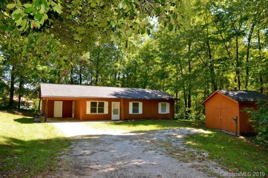 GREAT home in the heart of Marion NC! Property sits in city limits and offers nice yard space, parking area, and privacy...not something you see every day in city limits! Interior of home features NEW carpet, three bedrooms, and one bath. Eating area is right off kitchen! Plenty of closet space as well. Even more storage is offered with area off carport and then additional outbuilding. Must see to appreciate all this charming home has to offer. Act now and call today.