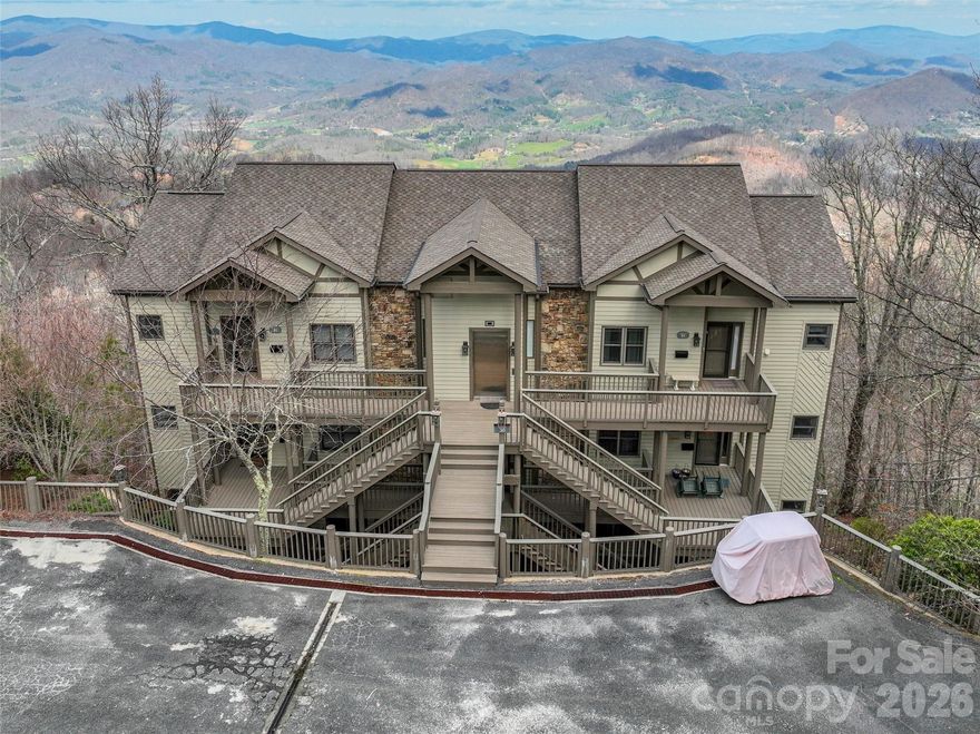 Step into mountain chic living with this beautifully updated 3BR/3BA Club Villas condo in the exclusive, gated MOUNTAIN AIR community. With breathtaking long-range northern views over Burnsville and stunning western sunsets from multiple private decks, this home blends style, comfort, and sophisticated mountain charm. The open, light-filled floor plan features soaring 9’9” ceilings, new luxury flooring, and a striking white-washed stone fireplace with built-ins, accented by a warm knotty pine ceiling in the great room. The beautifully renovated kitchen with marble countertops elevates everyday living, making entertaining effortless and stylish. Not ONE, but TWO, primary KING suites provide privacy and luxury, each with beautifully updated en suite baths, while all three bathrooms include modern bidet toilets with remote-controlled features. Three decks with recent wood flooring updates offer serene outdoor spaces to savor the panoramic scenery. Club Villa B offers the convenience of an on-site elevator for easier access! Just a short walk or golf cart ride from Mountaintop Club amenities—including golf, pickleball, fitness, dining, pro shop, and nature center (membership required)—this home offers unparalleled access to the full Mountain Air lifestyle. COMPLETELY FURNISHED with very few exclusions, the condo includes a 2017 gas golf cart, making it a turnkey mountain retreat ready to enjoy. A rare blend of luxury, comfort, and unforgettable views in one of the area’s most coveted locations. At this amazing list price, it won't last long.
