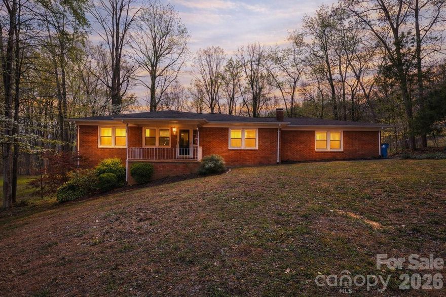 Charming full brick ranch with an open floor plan, spacious great room, and a cozy wood-burning fireplace in the dining area. The primary bedroom features a rare ensuite half bath—hard to find in homes of this era. Unfinished basement with garage provides excellent flexibility. Move-in ready with the opportunity to make it your own. Relax on the covered front porch or enjoy the private backyard backing to woods and bordering a creek. Tons of parking and a chicken coop included.  Check out our virtual tour.