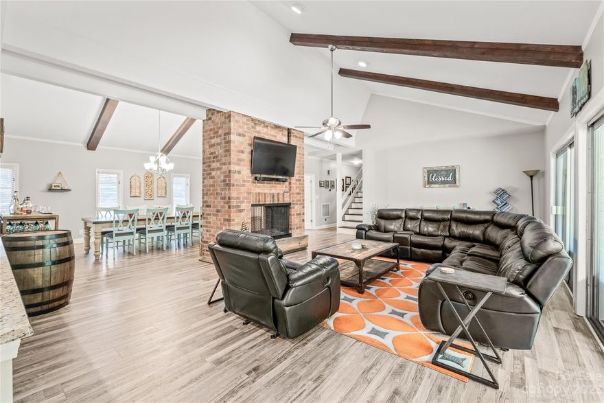 No fault of Sellers, home is back on the market.  Super unique, mid-century modern/rustic on the outside and modern, dramatic w/ soaring vaulted ceilings w/ wood beams, double sided, 2 story fireplace, completely open & totally renovated in 2016 on the inside! Brand new LVP flooring through out main level (no carpet!) If you love to entertain or to host large dinner parties, this home is for you! This home has it all! Large bedrooms, owner's suite on main, plus two add'l bedrooms, TONS of storage, a huge bed/bonus/flex space on the 2nd level--it would be a cool teen suite or in-law suite. The partial basement has oversized 2 car garage plus another flex space that could be a workshop! Current owner runs a small business out of it. There's add'l storage/workshop in the walk-in tall crawl space. All of this on an acre in Fort Mill, minutes from downtown FM! Excellent schools, NO HOA! Fenced backyard w/ trees providing so privacy! Corner lot w/cul de sac on the side!