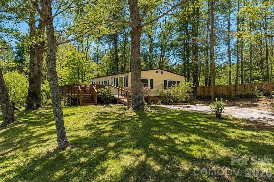 Priced below appraisal. Video Available. Welcome to your private South Asheville retreat! Situated on a rare, level 0.61-acre lot, this beautifully renovated home offers the perfect blend of privacy, convenience, and move-in-ready comfort. Tucked away on a quiet lane, you'll enjoy peaceful surroundings and seasonal lake views while remaining just minutes from everything that makes South Asheville one of Western North Carolina's most desirable locations.

Inside, the home has been thoughtfully updated with a newly renovated kitchen, bathroom, flooring, and all-new appliances, creating a fresh and inviting living space. Whether you're looking for a full-time residence, mountain getaway, or investment property, this home is ready for you to enjoy from day one.

The spacious lot provides room for gardening, entertaining, pets, outdoor hobbies, or future expansion possibilities. Unlike many mountain properties, the usable, mostly level yard offers easy access and plenty of outdoor enjoyment.

Conveniently located near South Asheville, Fletcher, and Hendersonville, you'll appreciate quick access to I-26 for commuting while being set back enough to enjoy peace and privacy. Enjoy easy access to Asheville Regional Airport, shopping, dining, healthcare, and the amenities of Biltmore Park Town Square, including restaurants, retail, fitness facilities, entertainment, and community events. South Asheville is known for its convenient access to shopping, dining, the Blue Ridge Parkway, and outdoor recreation.

If you've been searching for a renovated home with privacy, a large usable lot, mountain-area charm, and an unbeatable South Asheville location, this property deserves a closer look.