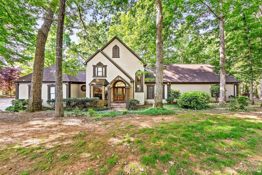 This custom waterfront home sits on an alluring tree-filled lot offering lots of privacy featuring private dock with boat lift. Large deck space and screened porch is excellent for entertaining while overlooking the water. Home is situated in a quiet cove that opens up to the main channel and surrounded by prepossessing Trump National Charlotte and The Point but w/o HOA dues. This richly appointed home’s well thought out floor-plan offers an abundance of living and entertaining opportunities featuring alluring wood flooring throughout the main level and upstairs.  The floor-plan has a dedicated office, formal dinning, chefs kitchen, gorgeous living room. The Grand Primary Bedroom on the main floor offers water-views, deck access, custom closet and private bath. Upstairs leads you to additional secondary bedrooms, a sitting room and 2 full baths. 

Entertaining is at premium with this home as it also boasts a finished basement with wet bar, rec area, media room and flex room.