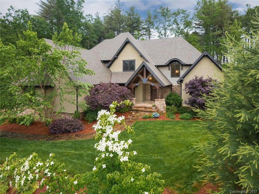 Mountain inspired shingle and stone home with an easy, open floor plan. Dramatic vaulted beamed ceiling in the great room that opens to the kitchen and outdoor living space.  Beautiful dark oak flooring, gray-washed cabinets, horizontal slate back-splash, honed granite counter tops and tasteful lighting give this home a cozy yet contemporary feel. Large and bright master on main. Located on a quiet street with community amenities; 24 hr security, pool, fitness ctr, walking trails & tennis courts