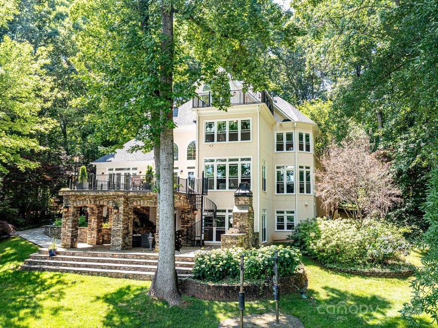 Amazing Price Improvement! Welcome to your newly transformed oasis on the shores of Lake Norman. Step into luxury as you enter this updated home, featuring fresh paint, new lighting and an abundance of natural light streaming through 43 new double hung windows.  Enjoy breathtaking waterfront views from the primary bedroom on main and new custom closet for your wardrobe essentials.  Convenience meets luxury with the ability to walk to Southlake School and easy access to uptown Charlotte.   The gourmet kitchen opens to a large gathering room, perfect for hosting large gatherings.  The lake level is an entertainers dream complete with billiard room, gym, full bath and kitchenette. This versatile space offers potential to be transformed into an in-law suite.  Outside, a covered stone porch with an 8-foot Koi pond and cascading waterfall.  Cozy up by the outdoor fireplace as you overlook Lake Norman, with a beach area and steps leading to your deeded boat slip within a park-like setting.