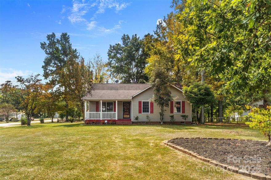 Come see this charming 3-bedroom home with a country feel, located close to the golf course. Welcome to this beautifully maintained 3-bedroom, 2-bath home that offers a perfect balance of peaceful living. The interior highlights a kitchen with abundant cabinetry and a beautiful bay window in the dining area, complemented by laminate flooring. The home features updated bathrooms and fresh paint throughout the interior, including the bedrooms and closets. You'll find beautiful, well-preserved hardwood flooring in the main living areas and a spacious living room with high ceilings and natural light. Step outside to a private backyard with a new deck off the primary bedroom. This home has a beautifully painted covered front porch, perfect for a relaxing and quiet evening connected to nature. The attached carport is ideal for entertaining or enjoying time with family and friends. The columns, windows, and crawl space door have all been freshly painted. This home is located in an established neighborhood with shady trees and no HOA, situated on a corner lot. It's a great opportunity for anyone seeking a cozy home with space for growth. Don't miss the chance to make it yours—schedule your showing soon!