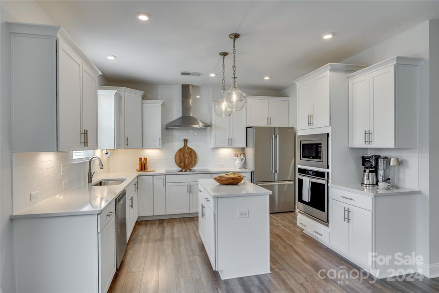 Better than new, this Mason's Bend home has been given designer touches throughout, & a backyard you won't want to miss! A rocking chair front poor greets you as you make your way in on LVP floors that run throughout the main level. Past a dining room w/ tray ceiling & gorgeous accent wall, you'll find a chef's kitchen w/ stainless steel hood, quartz counters, wall oven, pantry w/ solid shelving, & the cooktop has a gas hookup available. The great room is centered by a gas fireplace & looks out onto the expansive backyard. The enlarged back patio has a gorgeous pergola, stone fire pit, & huge fenced yard. Upstairs you'll find a primary suite w/ tray ceiling, walk in shower that boasts floor to ceiling tile, quartz counters, & custom closet. The generous loft upstairs gives flexibility, & don't miss the laundry room w/ custom shelving. Masons Bend resort style amenities include Catawba River launch, pool, fitness center, walking trails, elementary school on site, & more - welcome home!