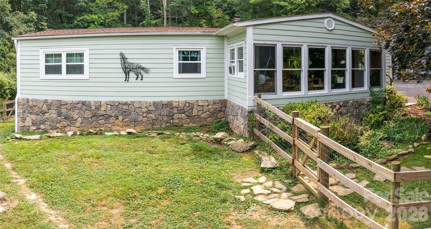 Tucked away at the end of a quiet dead-end drive, 74 Huntley Rd offers privacy, usable land, and an easygoing lifestyle just minutes from Asheville, Hendersonville, and the airport. Set on nearly 2 private acres, this property is ideal for buyers seeking a peaceful, animal-friendly setting without feeling remote. The home features single-level living with two bedrooms, which includes a spacious primary suite with private deck access. A screened porch creates the perfect extension of the living space—ideal for morning coffee, evening relaxation, or enjoying the surrounding nature year-round. Outdoor enthusiasts and gardeners will appreciate the fenced garden area, room for chickens or other animals, generous storage, and ample parking with a double carport. The property layout also offers potential space for an additional dwelling, making it well-suited for extended family, guest accommodations, or future flexibility. Whether you’re looking for a full-time residence, mountain retreat, or a private base close to everything Western North Carolina has to offer, this property delivers privacy, practicality, and lifestyle flexibility in one unique package.
Furnishings, décor, linens, and dishes are available for purchase. *Please note: due to the age of the manufactured home, this property will likely need to be a cash purchase.
Please do not enter the driveway without an appointment.