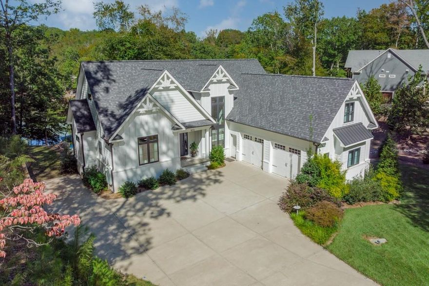 Gorgeous Award Winning "Best of The Lake" built by Titan Custom Builders waterfront home is a perfect blend of modern meets farmhouse with white brick, Hardi lap siding, board & batten and metal roof. Lineal iron & glass stair railing, beautiful hardwood floors, neutral gray paint and contrasting black windows with amazing views to the rear deck and lake. Soaring ceilings & an open kitchen with blue/gray custom cabinets, white marble countertops & subway tile. This super functional plan features a main level primary retreat to die for with coffered ceilings & beautiful views of Lake Norman. The Primary bath is an oasis with freestanding tub, gorgeous gray tile & glass enclosed shower. The basement stained concrete floors, gray cabinets & granite countertops that really is perfect for entertaining. Media Room, Office and Man Cave/Workshop that is finished/heated and could be converted to additional living space. Peaceful private cove with covered dock and deep water.