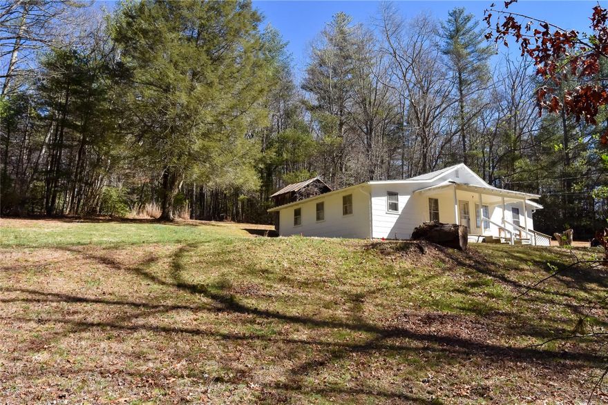 Check out this private home located on 2.22 acres close to downtown Spruce Pine.  This property is at the end of the road providing a wonderful private area with wooded forest around 3 sides of the parcel and a large yard. Make this 3 bedroom home your own or your next investment property.   This home is move-in ready, with a large living room, freshly painted walls, and a new porch.  Come see this home!