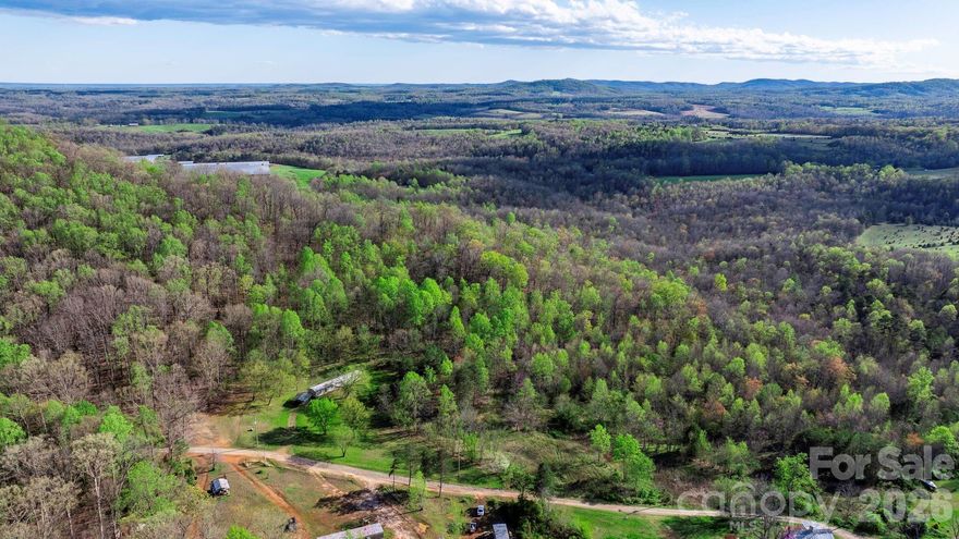 Embrace the tranquility of over 26 acres in Wilkes County, offering unrivaled privacy and breathtaking panoramic mountain views. This vast expanse of land presents a unique opportunity to build your dream home surrounded by nature's beauty or to create a personal hunting retreat abundant with wildlife. With its serene environment and picturesque landscapes, this property is the perfect escape to a peaceful life or a thrilling adventure in the great outdoors. Experience the best of both worlds, where your visions of a custom-built oasis or a hunter's paradise can become a reality.
