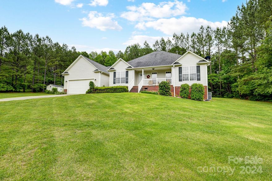 Extremely spacious ranch home on a private acre lot in a country setting only approximately 5 miles from 77. The town of Catawba is right south of Rock Hill and part of the Rock Hill School District. This home features a split bedroom plan with a large sitting area in the primary bedroom. Fridge, washer and dryer included. All walk in closets. Huge dining and living areas. Covered back porch extends almost the length of the home. Wired storage building out back, full yard irrigation and whole house surge protection. You’ll love the privacy with wooded areas on both sides and the back of the lot. House will have a new roof before closing!