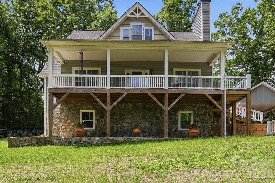 PRICE IMPROVEMENT! Welcome to this charming modern farmhouse retreat on 10+ private acres, offering the perfect blend of rustic charm and contemporary comfort. Just a quick 30 minute drive from the Charlotte airport you'll find picturesque, mountain-like view from this rocking chair front porch, and a spacious covered rear deck where you can relax and unwind.

The open-concept main level features hardwood floors and a wood-burning fireplace, creating a warm and inviting atmosphere. The light-filled kitchen showcases custom cabinetry, ample storage, and generous counter space—ideal for cooking and entertaining.

The main-level primary suite includes a private en suite with an over-sized soaking tub, separate over-sized shower, private water closet, dual sinks, and a spacious vanity.  A large walk-in closet provides abundant storage for your wardrobe. Upstairs, two generously sized bedrooms and a full bath provide flexible space for a home office or growing family.

The partially finished basement is waiting for your personal touch. It offers endless potential with a chimney for future wood-stove installation, and plumbing in place for future design. A separate exterior entrance makes this space perfect for so many possibilities including a guest suite, entertainment area, or a home gym. 

Outside, a custom designed covered carport complements the home and protects your vehicles from the elements. A personal storage building is conveniently located for your tools and equipment. There is a fenced area in the back yard for your pets to enjoy. Mature fruit-bearing trees for your pleasure include 2 pear and 1 plum. There is also a fig bush. 

The wired, lighted workshop has a concrete floor and includes an automotive lift that awaits your next project or hobby, perfect for DIY enthusiasts or anyone needing extra space for their crafts or work. A small barn with a fenced pasture adds character and function to the property. A serene creek runs through the middle of the home-site just beyond the workshop and barn. You will cross over it as you drive up to the home.

With ample space for outdoor activities, gardening, or even livestock, this property offers endless possibilities. Whether you're looking for a quiet country escape, a hobby farm, or simply a peaceful retreat to call home, this property is the perfect place for rural living with modern style.
