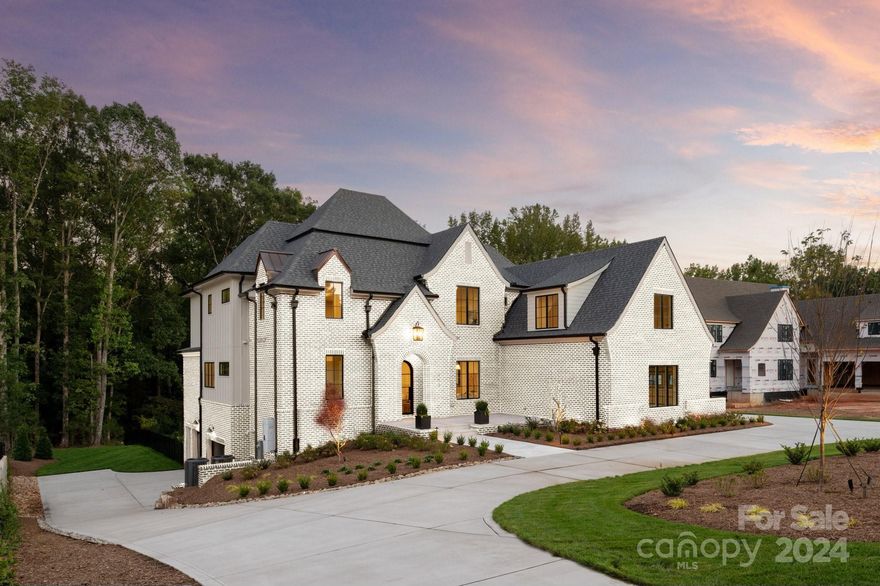 Option to paint exterior brick white as shown in rendering | A truly unique gem in the coveted Cardinal Crest community in Weddington, NC, this semi-custom estate home is situated on an approximately 1-acre private, wooded lot. This luxury residence boasts a gourmet kitchen equipped with high-end appliances, custom cabinetry, quartz countertops, and double islands, seamlessly flowing to the spacious family room with a gas fireplace. The main-level primary suite offers a spa-like bathroom and expansive walk-in closet. Additional living spaces include a versatile bonus room, a theater/media room with concession area, and a cozy loft. Outdoor living is a delight with a saltwater pool, spa, screened porch, and covered terrace. The lower level features a second family room, theater room, guest suite, and ample storage. With easy access to I-485, shopping, and dining, this home provides the perfect blend of luxury, privacy, and convenience in Weddington.