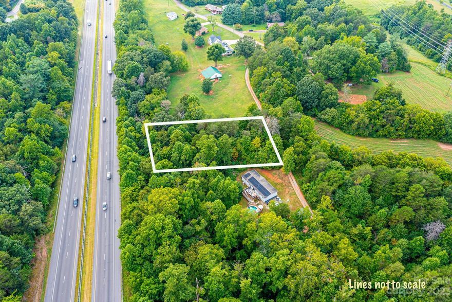 Great value to build on this private wooded lot.  Very convenient location to Rutherford College Exit 113.
Doublewide may be placed on this lot.  Needs a well.  Public sewer is available. Tap fee is $1,525.
