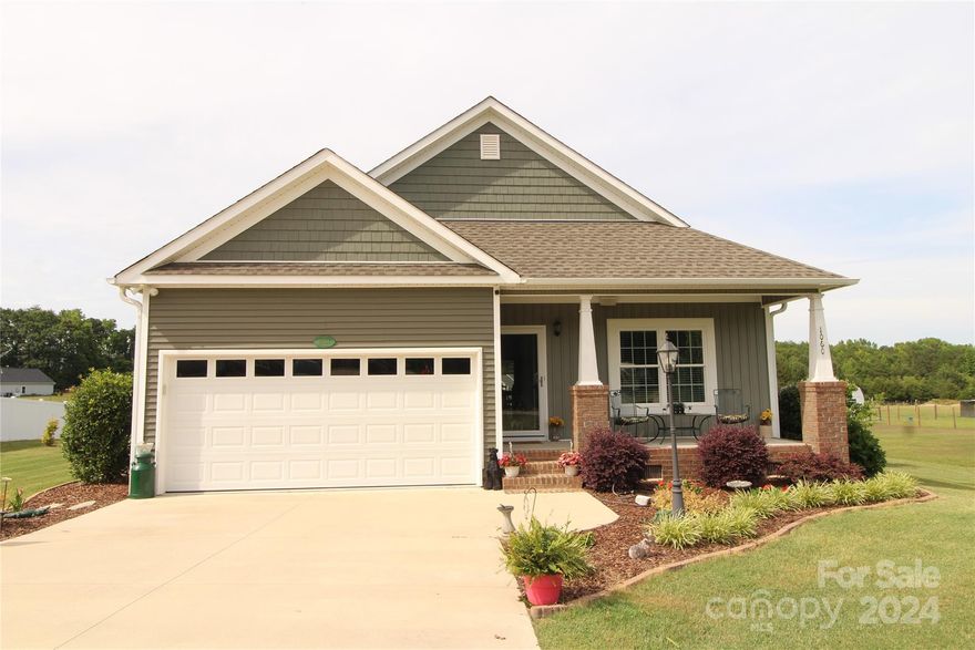 If you are looking for a craftsman style home outside the city limits of Clover without an HOA then this may be the home for you!  This home shows like new!  This home has approximately 1482 heated square feet with 3 Bedrooms, 2 Bathrooms & attached 2 car garage. Vaulted ceilings in the Great Room, Kitchen & Dining area. Large primary bedroom with tray ceiling, ceiling fan, walk-in closet and additional closet.  Primary Bathroom features double sinks, tile shower and a granite counter top. Wood flooring throughout the majority of the house except the bathrooms and laundry room that have tile flooring. The kitchen features stainless steel appliances, granite counter tops and a breakfast bar. Plenty of areas for outdoor enjoyment with the covered front porch, screened porch and patio. Built-in Speakers in the Great Room, Front Porch & Screened Porch. For additional storage there is an 8'x12' storage building that has power to it.  Schedule an appointment to see this wonderful home soon!