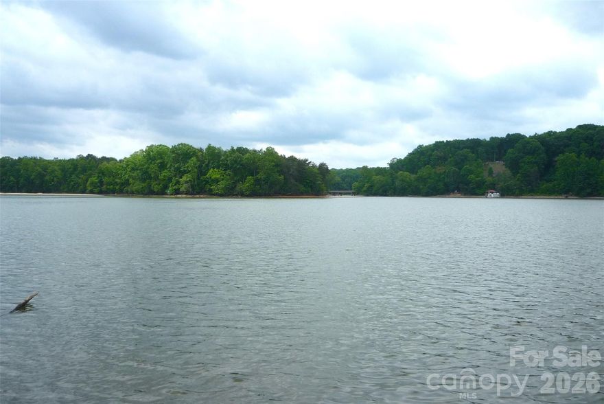 This wooded, sloping lot which is perfect for a walk-in crawl space or for a walkout basement leads you to a MAIN CHANNEL VIEW with 146 feet of water frontage; This lot is located on the right side of the road and just before the cul de sac; With no time frame to build, have your own builder build your dream home; The minimum sqft for your future home is 2,000; This lot is located just 10 minutes to a public boat launch;  Ridgewood is a smaller, quiet community with just a few roads and not even half of the lots have been built on; Enjoy Iredell County and its low property taxes; This property is close to the downtowns for Catawba, Claremont and Troutman; See the MLS attachments for information on the very minor encroachment by the property behind this lot;