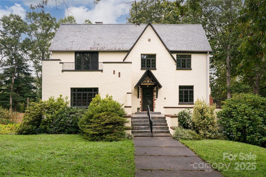 Charm meets modern potential in this Tudor Revival home located in Asheville’s historic Griffing Rose Garden section of the Grove Park neighborhood. Situated on a generous .68-acre landscaped lot, the property offers an inviting Baquacil swimming pool, fenced yard,  wildflower gardens, and plenty of room to play. Step inside and you’ll find the elegance of yesteryear, complemented by a large primary suite along with three additional bedrooms and baths. The home offers a spacious walk-up attic and a full basement with bath, office, garage, and laundry, ready for thoughtful updates. This is a rare opportunity to customize and bring new life to a classic residence. Additional features include an EV charger, a recently replaced pool liner, and a newer slate roof at the rear.