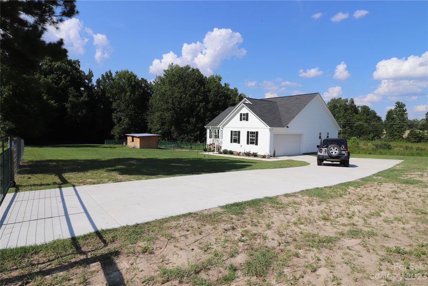 Beautiful country farmhouse on an acre of land newly constructed in 2022 located in the Heath Springs community. The spacious Primary Bedroom has a private bath with double vanity with granite counters and walk in shower. The gorgeous kitchen features stainless appliances, kitchen island and granite counters with custom cabinetry. Home includes a 2 Stall 12ft x 28ft Horse Barn. Come enjoy your evenings on the covered front porch or on your private back deck.
