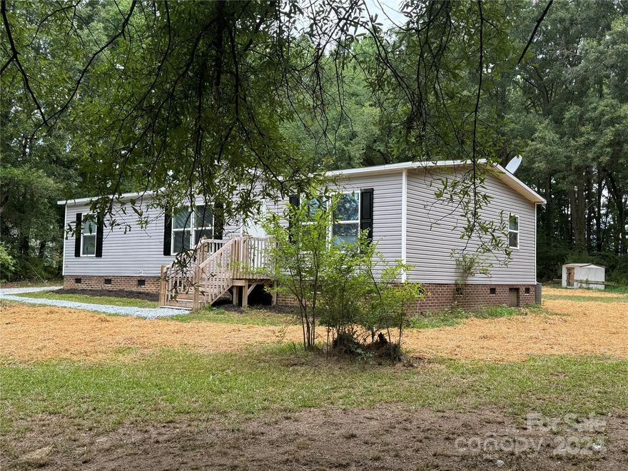 Built in 2021 Approximately 1302 Sq Ft, 3 Bedroom 2 Full Bath Manufactured Home. Living Room, Island Kitchen, Dining Area, Main Bath/Bedroom with Walk in Closet, His and Hers Vanity, Garden Tub, Separeate Shower. Central Heat and Air, Public Water, Permanent Foundation, Private Septic, 3 Acres, Small Pond, Partially Wooded. Seller installing Union County Water prior to close at no cost to buyer.