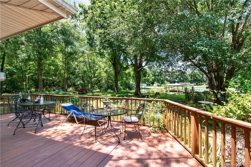 Welcome to your piece of paradise in Lancaster, SC! Imagine coming home to enjoy your evenings on the large back porch covered in mature shade trees, listening to the birds singing and gazing out over the community lake. On weekends, enjoy fishing in the lake, or working on your hobbies in 1 of the 2 large storage buildings, complete with electricity! The inside of the home has been lovingly maintained, and boasts a large family room with loads of natural light.