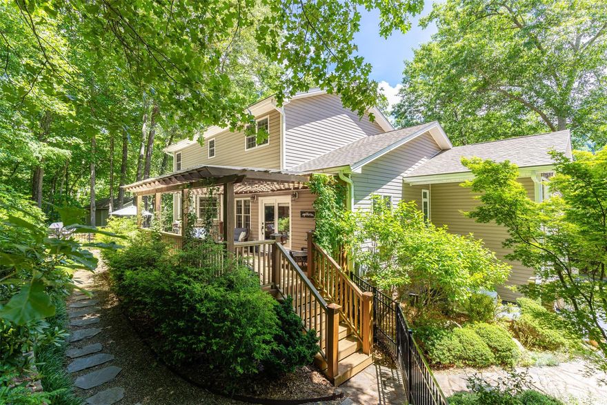 Welcome to 72 Whitfield Lane in the beautiful Seven Glens community–conveniently located within an easy drive of Asheville, Weaverville, and Mars Hill. Peaceful tranquility awaits! Set on 1.67 acres, the curated landscaping and natural beauty create a true outdoor retreat. Stroll along winding stone pathways past a cascading waterfall and enjoy the ultimate setting for outdoor entertaining. A private covered back porch provides a seamless transition into the light-filled kitchen and dining area, perfect for effortless indoor/outdoor living. Inside, the home offers flexible living space across three levels—ideal for a variety of lifestyles. Thoughtfully maintained with extensive upgrades, this property delivers both comfort and peace of mind. Recent improvements include a new roof with gutter guards (2024), well pump (2024), whole house generator (2021), water filtration system with softener and UV light (2021), updated light fixtures (2021), furnace (2020), and aluminum fenced yard (2020). Additional enhancements include GE Profile kitchen appliances, window treatments and a two-person infrared sauna. With major systems updated and a setting that feels like a private oasis, 72 Whitfield Lane offers the perfect balance of convenience, functionality, and serene mountain living.