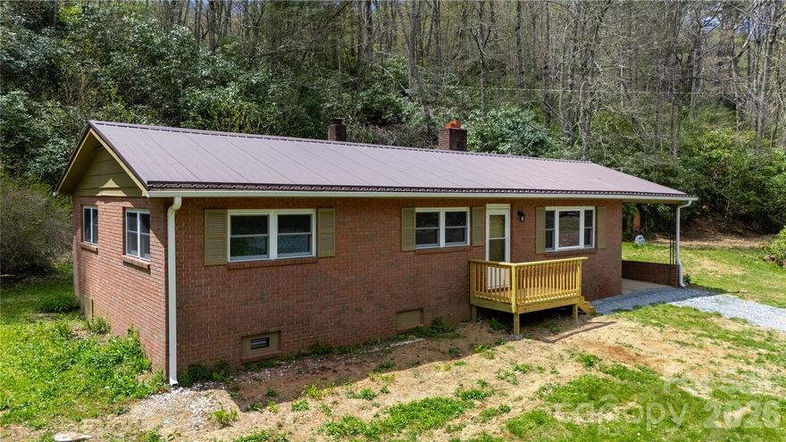 Private Mountain Retreat | No HOA | Short- & Long-Term Rentals Allowed.
Tucked away at 3,578 feet elevation in the heart of North Carolina’s High Country, this charming 3-bedroom, 1-bath brick home offers true peace and privacy on approximately 1 level acre. No other homes are in sight and a gentle small stream meanders through the front yard, creating a soothing soundtrack and picturesque setting.
Completely refreshed and move-in ready, this single-level home features:

*Brand new luxury vinyl plank flooring throughout
*New energy-efficient windows
*New granite countertops and beautiful cabinetry
*All new stainless steel appliances
*New HVAC system
*New guttering
*Durable metal roof

A cozy brick fireplace anchors the living space, perfect for cool mountain evenings. At roughly 1,222 sq ft, the home is efficiently laid out and easy to maintain.  Whether you're seeking a peaceful full-time residence, a weekend getaway, or a profitable rental property, this home checks every box. There are no HOA fees or restrictions, and both long- and short-term rentals are permitted.
Location Highlights:

*Walk to the Blue Ridge Parkway
*Just 9 miles to Grandfather Mountain
*4 miles to Linville Land Harbor
*9 miles to the vibrant, growing town of Newland
Boone, Banner Elk, Sugar Mountain & Beech Mountain Ski Resorts, Morganton, and Lake James All within a 30-minute drive: 

Nature lovers and adventure seekers will appreciate the easy access to hiking, biking, fishing, and scenic drives. Unwind with a visit to nearby Linville Falls Winery or Banks Creek Barn for local wine, craft beer and good times.
This elevated mountain retreat delivers the perfect blend of seclusion, modern comfort and unbeatable access to everything the High Country has to offer — all at an incredible value.  Ready for your mountain chapter? Schedule your private showing today.