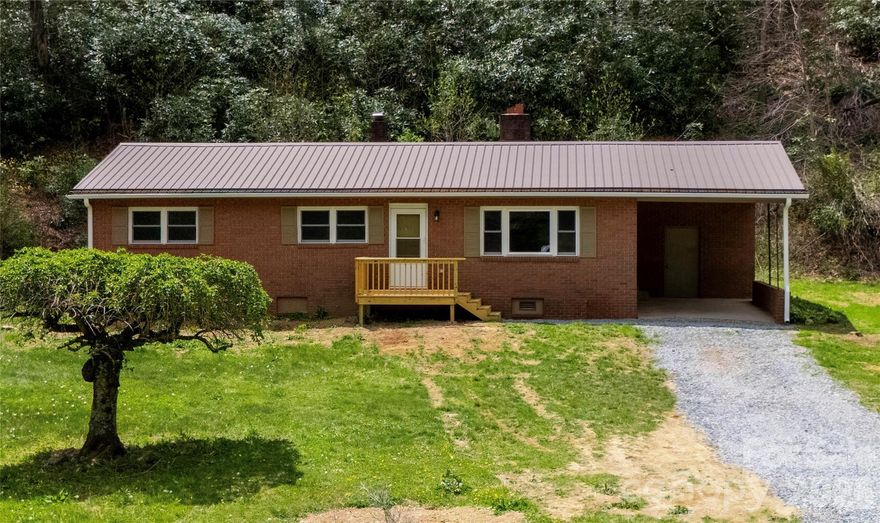 Private Mountain Retreat | No HOA | Short- & Long-Term Rentals Allowed.
Tucked away at 3,578 feet elevation in the heart of North Carolina’s High Country, this charming 3-bedroom, 1-bath brick home offers true peace and privacy on approximately 1 level acre. No other homes are in sight and a gentle small stream meanders through the front yard, creating a soothing soundtrack and picturesque setting.
Completely refreshed and move-in ready, this single-level home features:

*Brand new luxury vinyl plank flooring throughout
*New energy-efficient windows
*New granite countertops and beautiful cabinetry
*All new stainless steel appliances
*New HVAC system
*New guttering
*Durable metal roof

A cozy brick fireplace anchors the living space, perfect for cool mountain evenings. At roughly 1,222 sq ft, the home is efficiently laid out and easy to maintain.  Whether you're seeking a peaceful full-time residence, a weekend getaway, or a profitable rental property, this home checks every box. There are no HOA fees or restrictions, and both long- and short-term rentals are permitted.
Location Highlights:

*Walk to the Blue Ridge Parkway
*Just 9 miles to Grandfather Mountain
*4 miles to Linville Land Harbor
*9 miles to the vibrant, growing town of Newland
Boone, Banner Elk, Sugar Mountain & Beech Mountain Ski Resorts, Morganton, and Lake James All within a 30-minute drive: 

Nature lovers and adventure seekers will appreciate the easy access to hiking, biking, fishing and scenic drives. Unwind with a visit to nearby Linville Falls Winery or Banks Creek Barn for local wine, craft beer and good times.
This elevated mountain retreat delivers the perfect blend of seclusion, modern comfort and unbeatable access to everything the High Country has to offer — all at an incredible value.  Ready for your mountain chapter? Schedule your private showing today.  All Pictures with furniture are virtually staged.