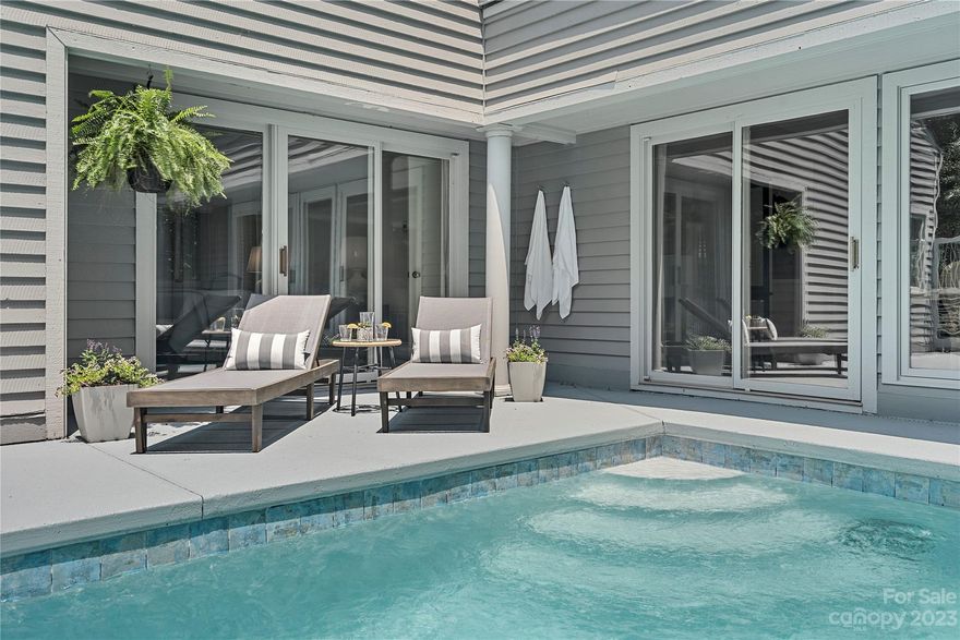 A custom work of art. Built in 1988 by the talented architect Hal Tribble, you are taken back upon entry with the interesting lines and curves of this home. The main event here is the European style pool situated in the center of the home and visible from the living room , dining room, primary and hall, this area will certainly wow your guests for entertaining. Natural light pours in from the many architectural windows throughout the home. It's all in the details, with custom moldings, built in curios, modern doors and sleek finishes. The curved screened in patio is another living area in itself, perfect for all seasons. Home's primary bedrooms features an exquisite design with dual separate  dressing areas for the owners. Both secondary bedrooms upstairs have ensuite bathrooms. A dedicated office and full basement with half bath makes this home functional for all needs. Dive on into a piece of art. in this Beautiful home in tranquil, lakefront/golfing resort community of River hills