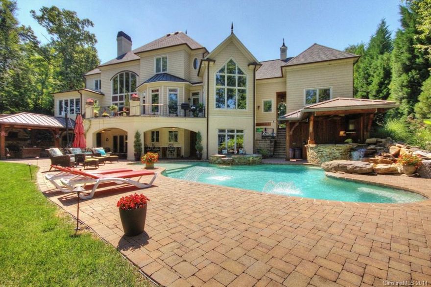 Elegant 3 level waterfront home full of upgrades, stylish faux finishes & private pier. Desired master on the main & open floor plan boasts lots of natural light & two story Great Room. Take one of two staircases up to 3 addt’l bedrooms, each with their own bath, plus a bonus room. Enjoy entertaining in the downstairs rec room w/ bar, wine cellar, theater room, 5th bedroom & exercise room.  Walk out to a lake level breathtaking outdoor space complete w/ pool, spa, outdoor kitchen & sitting area.